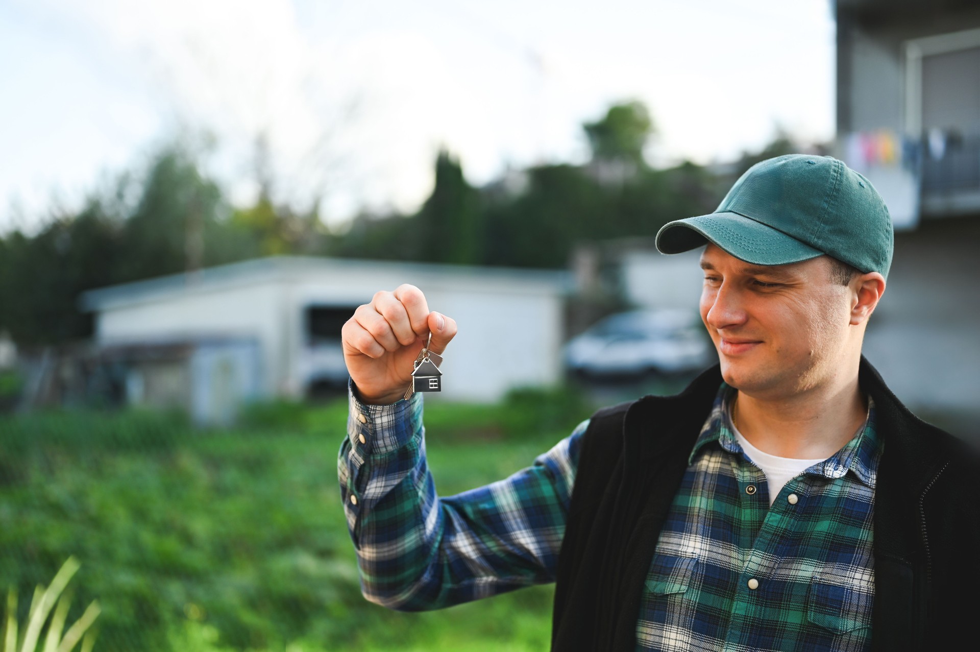 Man holding keys to his new house