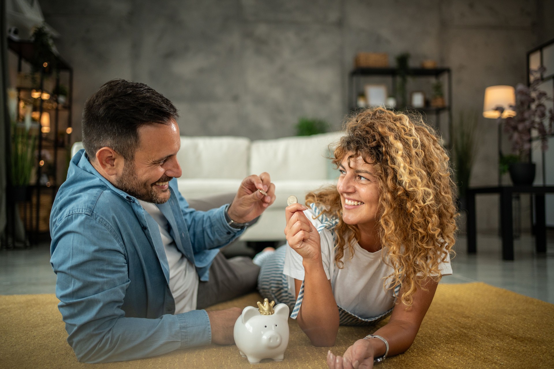 Happy young couple saving money for their next investment, shopping or vacation