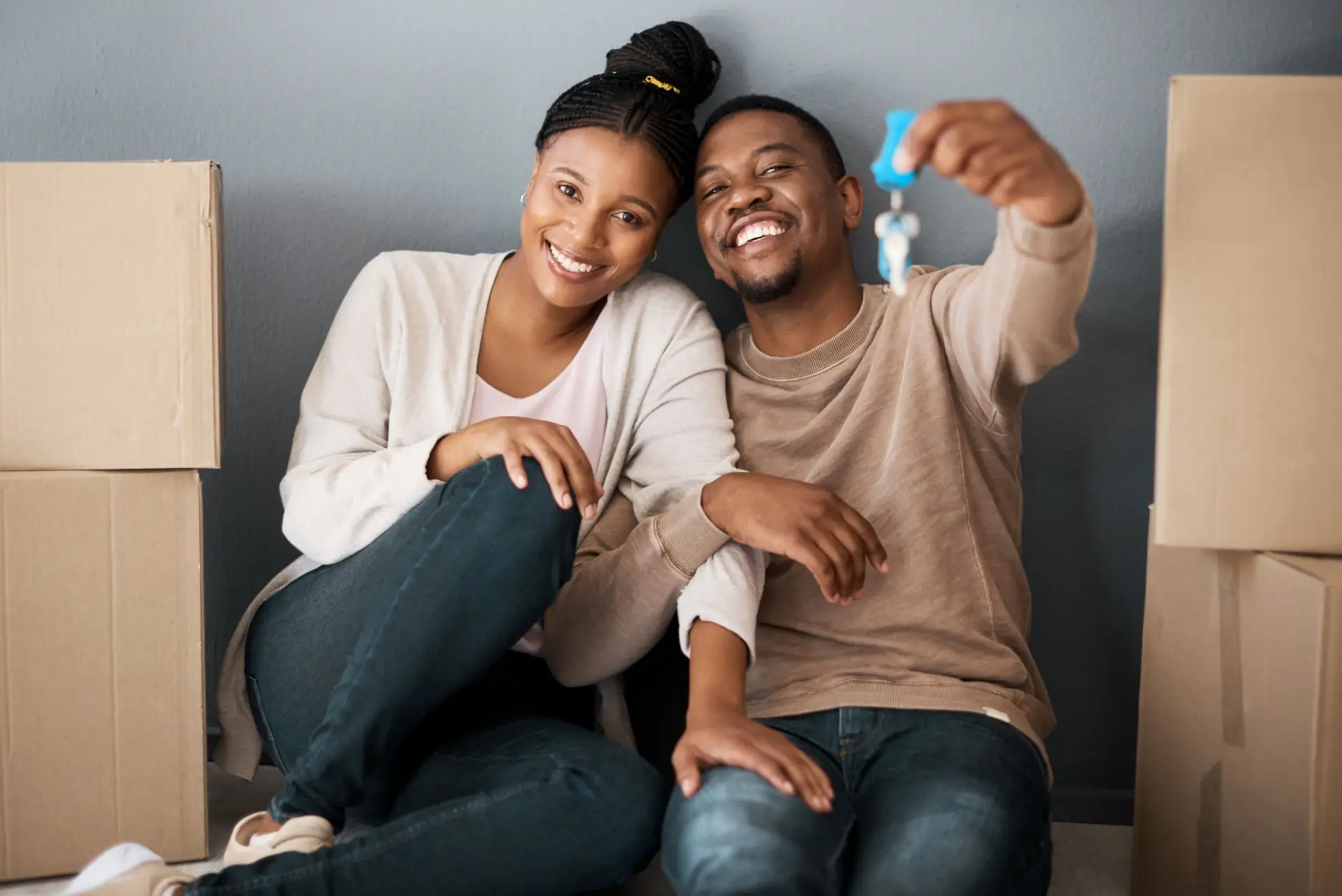 First-time home buyers holding the keys to their new home